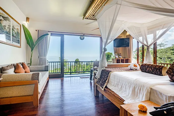 A Luxury Suite with a king-size bed and glass doors to the terrace