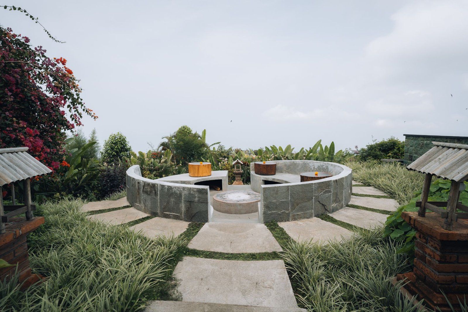 The stone fire-pit seating area at Rasa Alam among the plantation gardens